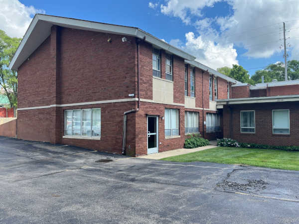 Exterior photograph of the entrance door used to access the center, seen from the Farnum Ave. parking lot.